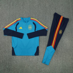 Chándal España 2026-2027 Legacy con sudadera turquesa y pantalón azul marino, vista frontal
